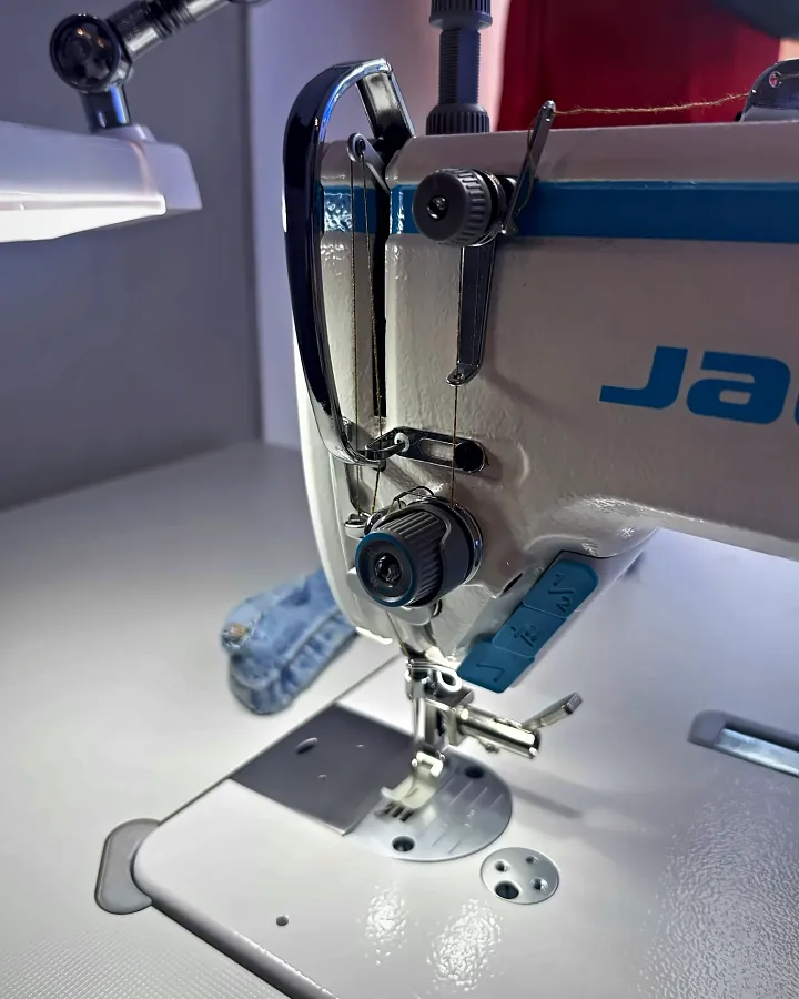 Eine Industrienähmaschine, eingefädelt für eine Jeans-Reparatur